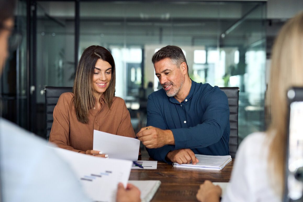 Professional executive business group working with documents at office meeting.